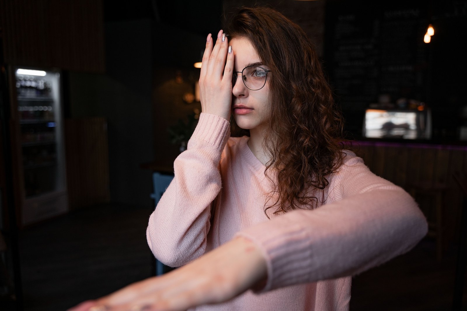 the girl covered one eye with her hand, stands in glasses for vision